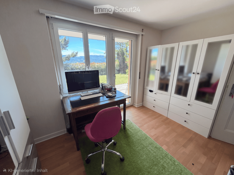 Furnished Room. A well-lit room with wooden flooring, a large window offering a scenic view, a desk with a computer setup, a pink office chair, and a white wardrobe with mirrored doors.
