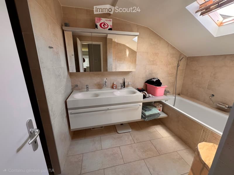 Modern bathroom with a double sink, large mirror, bathtub, and tiled walls and floor. Features include a skylight window and a small shelf with towels and toiletries.