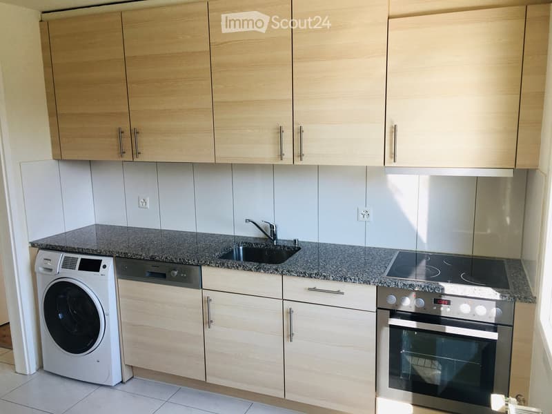 modern kitchen with wooden cabinets, granite countertops, stainless steel appliances, white floor