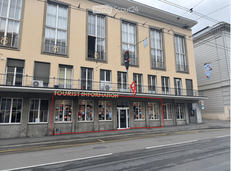 Four-story building with large windows, a balcony on the second floor, and a storefront labeled "TOURIST INFORMATION" at the ground level.