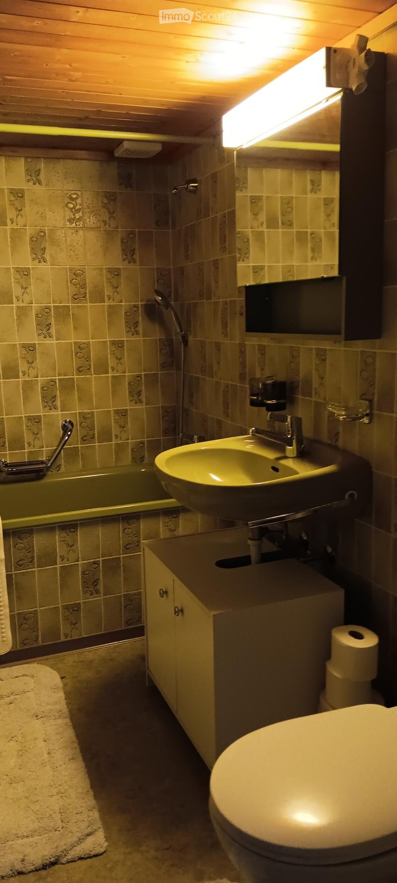 Bathroom: bathtub, toilet, sink, wall mounted cabinet, white tiles, shower