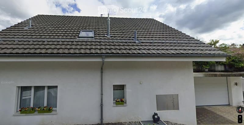 Single-story house with a tiled roof, white exterior, multiple windows, and flower boxes on the windowsills.