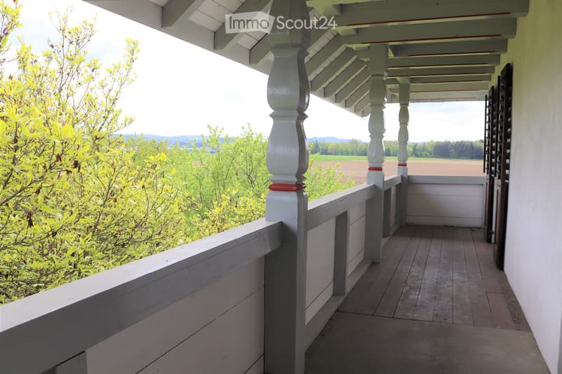 wooden balcony, railing, wide view, sunlight