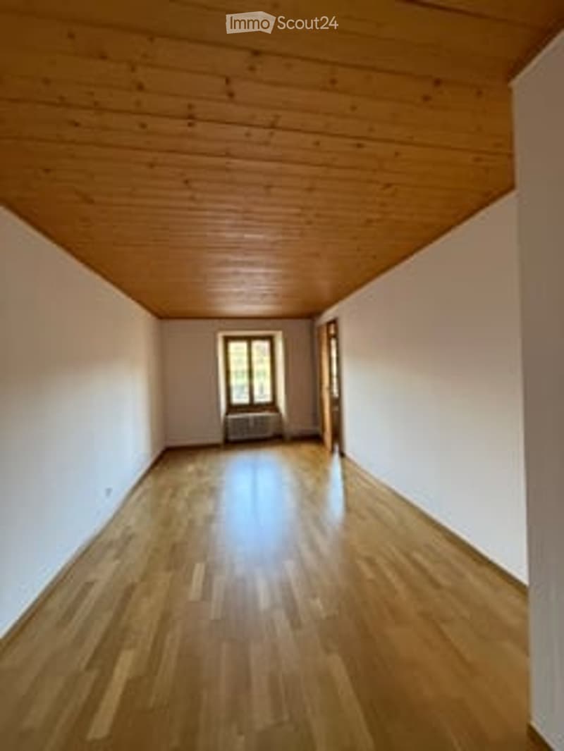 Unfurnished Room. Empty room with wooden flooring and white walls, featuring a single window and a radiator.
