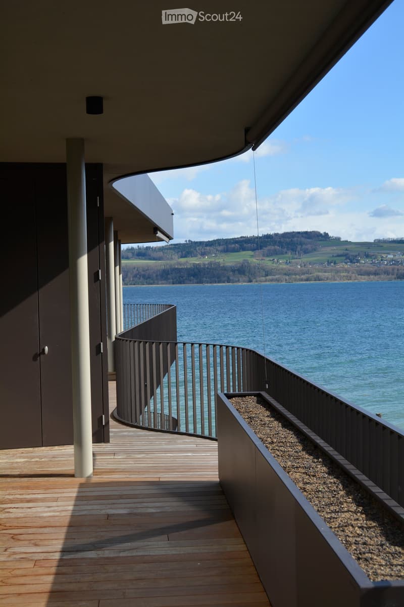 wooden floor, metal railing, large balcony, lake view