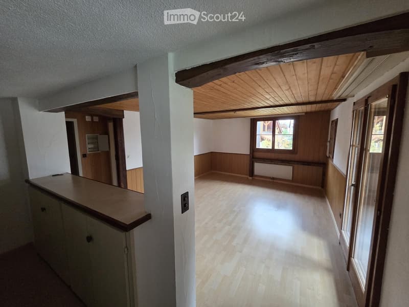 empty room with wooden wall, wooden ceiling, wooden floor, and windows