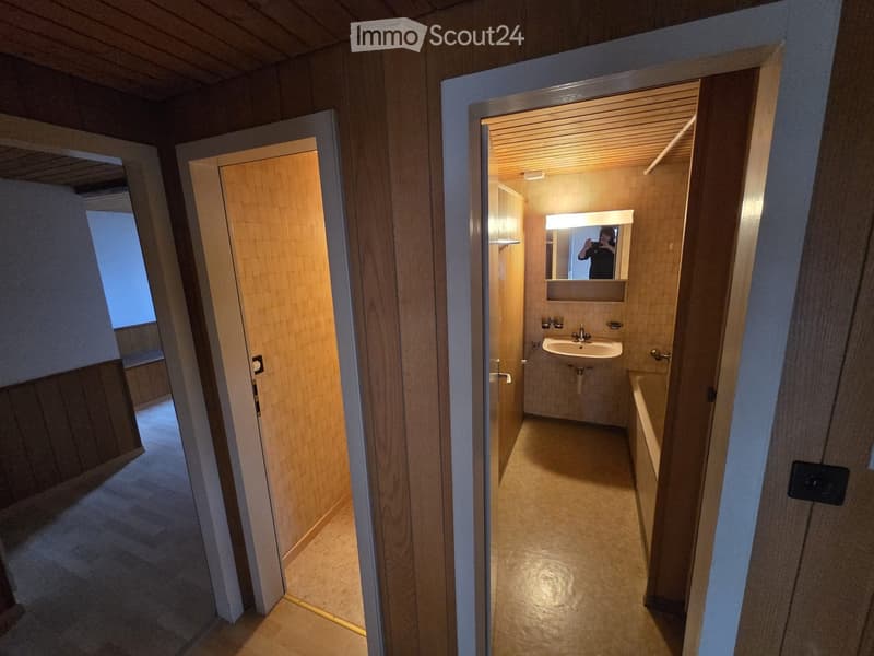 Small bathroom with sink, bathtub and mirror