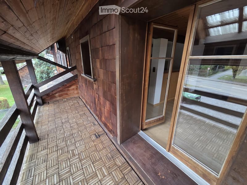wooden floor, wooden walls, sliding glass door leading to interior, balcony railing