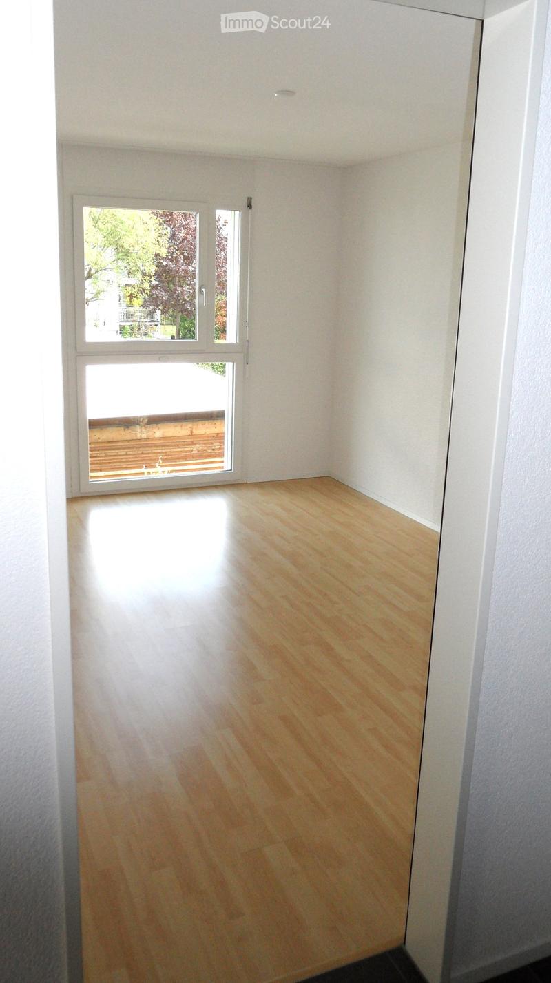 Unfurnished Room. Completely empty room with white walls, wooden floor, and a large window.