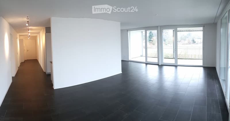 Unfurnished Room. An empty room with white walls, black tiled floor, and a large window leading to a balcony.