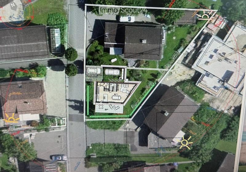Aerial view of a residential property with a detailed floor plan overlay, showing multiple buildings, parking areas, and landscaped spaces.