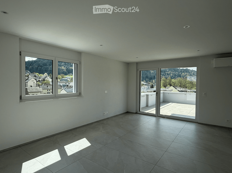 Unfurnished Room. Empty room with large windows and sliding glass doors leading to a balcony, featuring a tiled floor and neutral-colored walls.