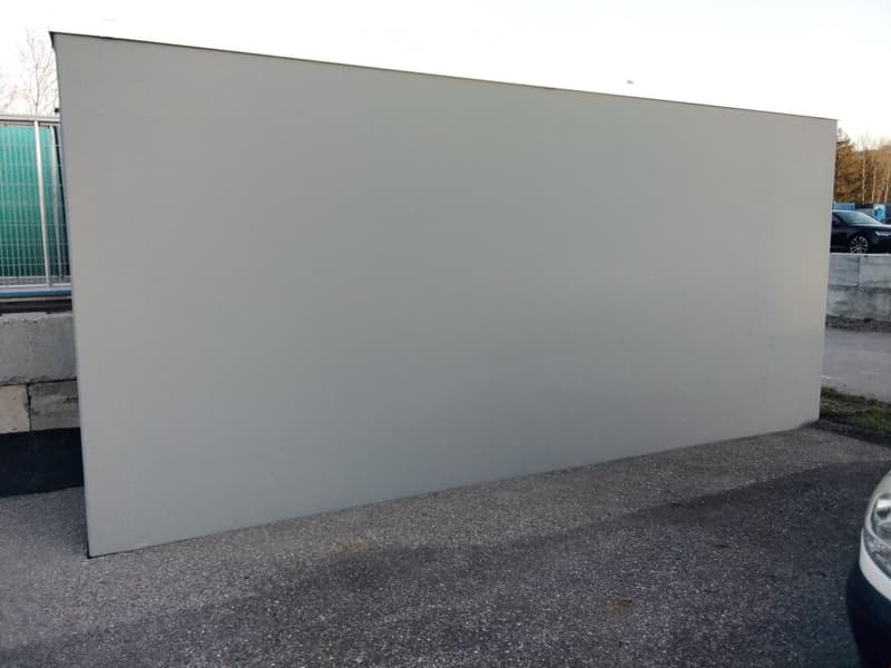 A modern, minimalist building with a smooth, light-colored facade and a clean, contemporary design.