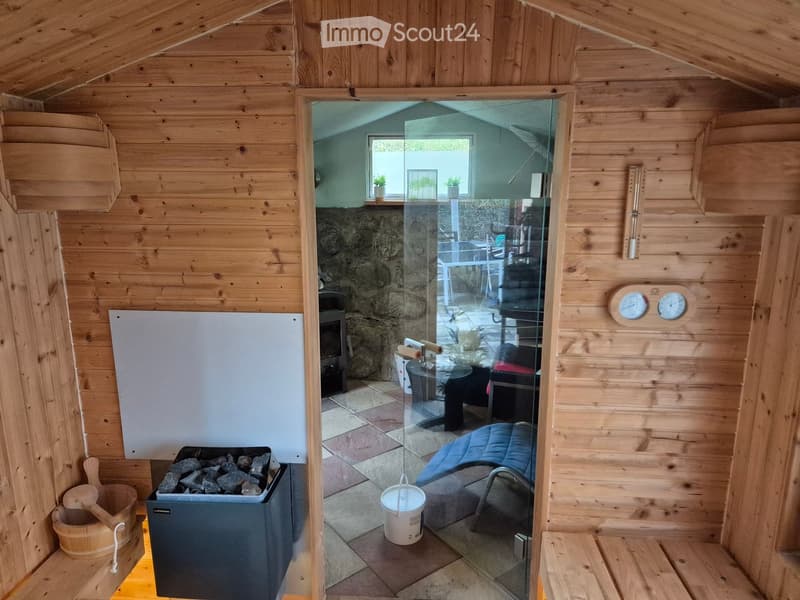 {"type": "Furnished Room", "objects": ["sofa", "table", "chair", "stool", "wooden bucket", "wooden spoon", "wooden shovel", "wooden paddle", "wooden thermometer", "wooden clock", "wooden shelf", "wooden cabinet", "wooden door", "wooden wall", "wooden floo