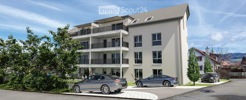 Modern multi-story residential building with balconies, large windows, and several parked cars in front.