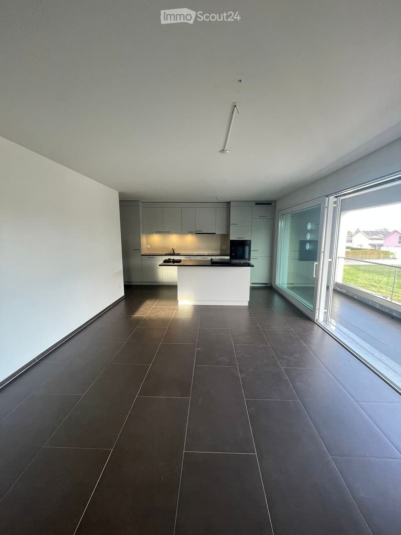 {"visible_features": ["Balcony / Terrace"],"type": "Apartment","description": "Open-concept living space with a modern kitchen, large windows, and tile flooring. The kitchen features white cabinets and a black countertop."}