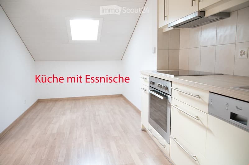 Modern kitchen with light wooden flooring, white walls, and built-in appliances including an oven, dishwasher, and range hood.
