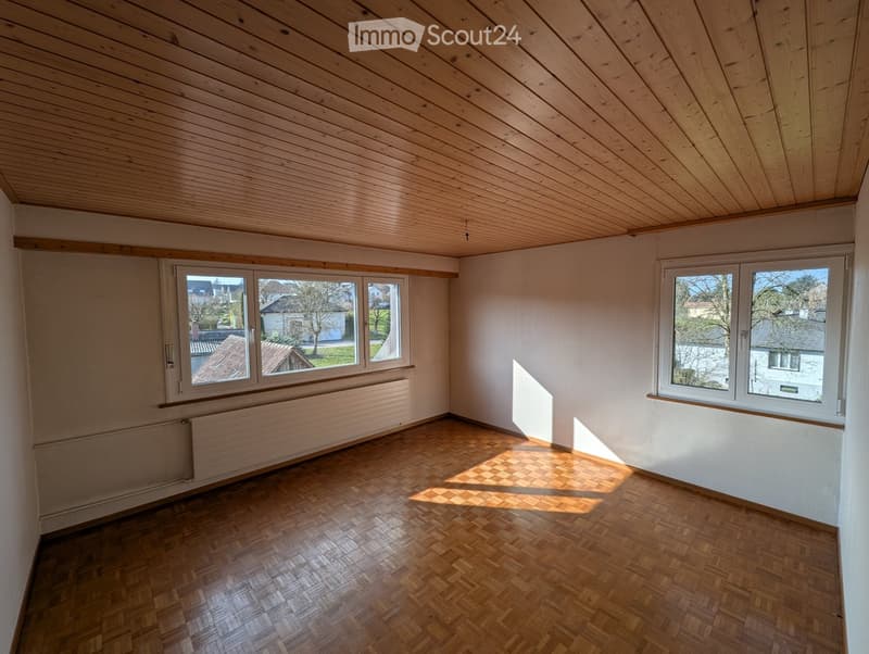 empty room, wooden floor, wooden ceiling, two windows, white walls, radiators