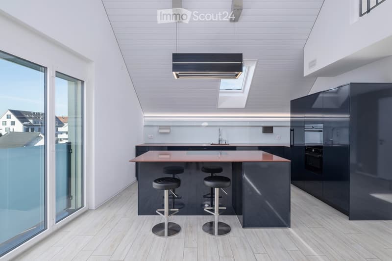 Modern kitchen with a central island, four black stools, sleek dark cabinets, and a large window offering a view of the city.