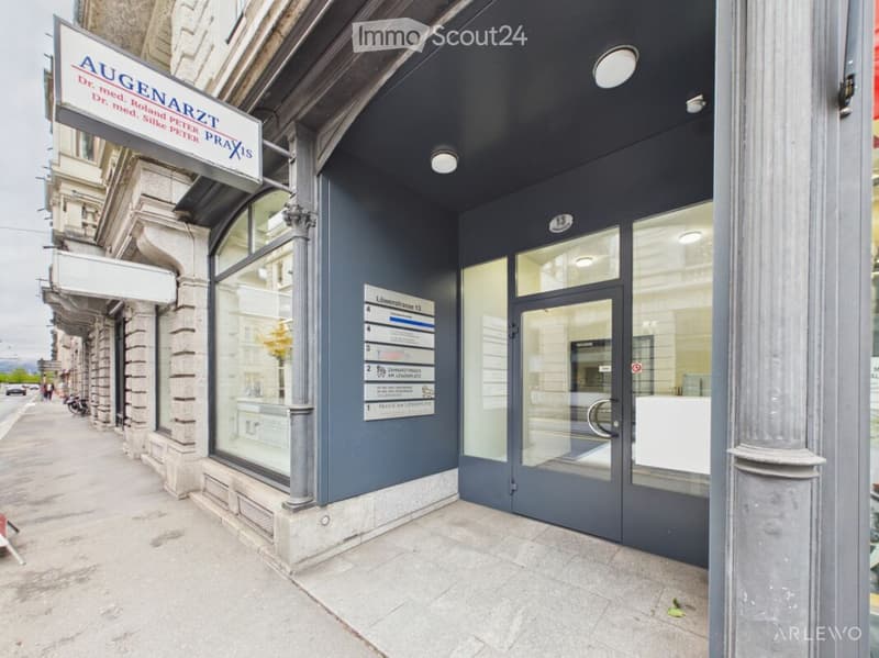 Facade of a building with a sign for a medical practice, glass doors, and a directory board listing office numbers.