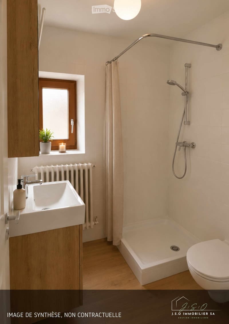 Modern bathroom with a white sink, faucet, toilet, bathtub, and showerhead. Features a wooden cabinet, a window with a small plant and candle, and a radiator below the window.