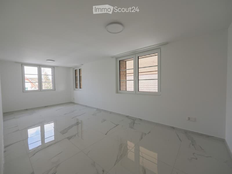 Empty room with white walls, marble flooring, and multiple windows allowing natural light. No furniture or equipment is present.
