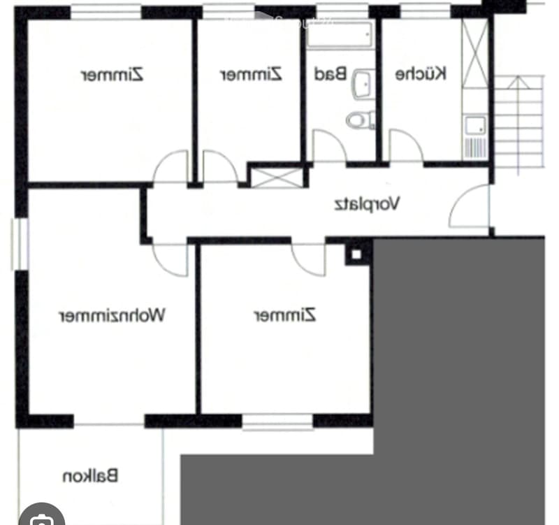 Floor plan of a house with four bedrooms, two bathrooms, a living room, a kitchen, and a balcony.