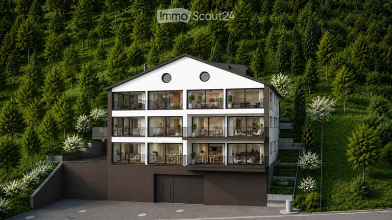 Modern3-story house with large glass windows and balconies, surrounded by lush green forest, featuring a garage and raised ground floor.