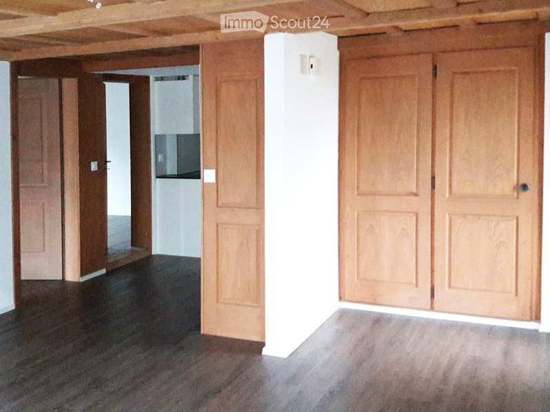 Unfurnished Room. Empty room with wooden doors, white walls, and dark flooring. No furniture or equipment visible.