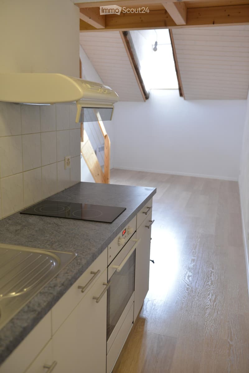 kitchen with stove, oven, sink, cabinets, wooden floor, attic