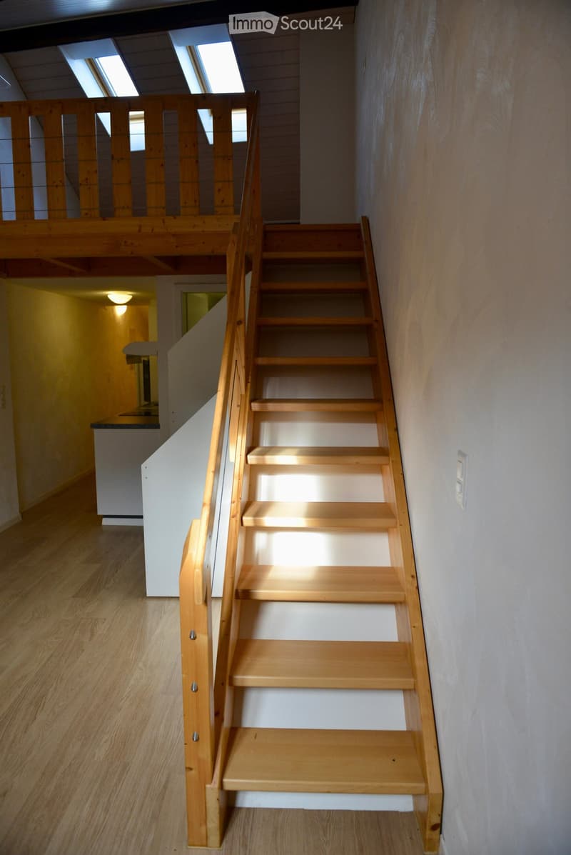 wooden stairs, wooden handrail, wooden floor, white wall, skylights