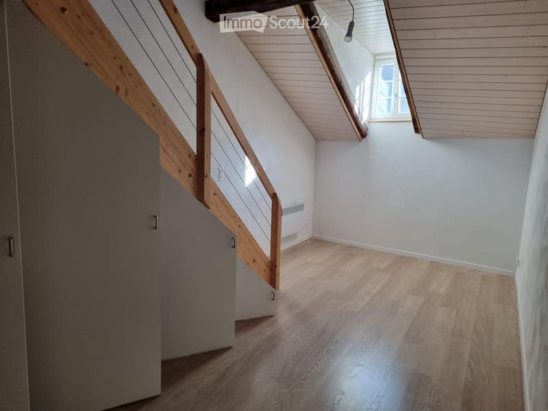 empty room, wooden floor, wooden staircase, white walls, wooden ceiling, small window