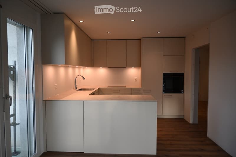 white cabinets, stainless steel appliances, white countertop, modern sink, faucet, power outlets