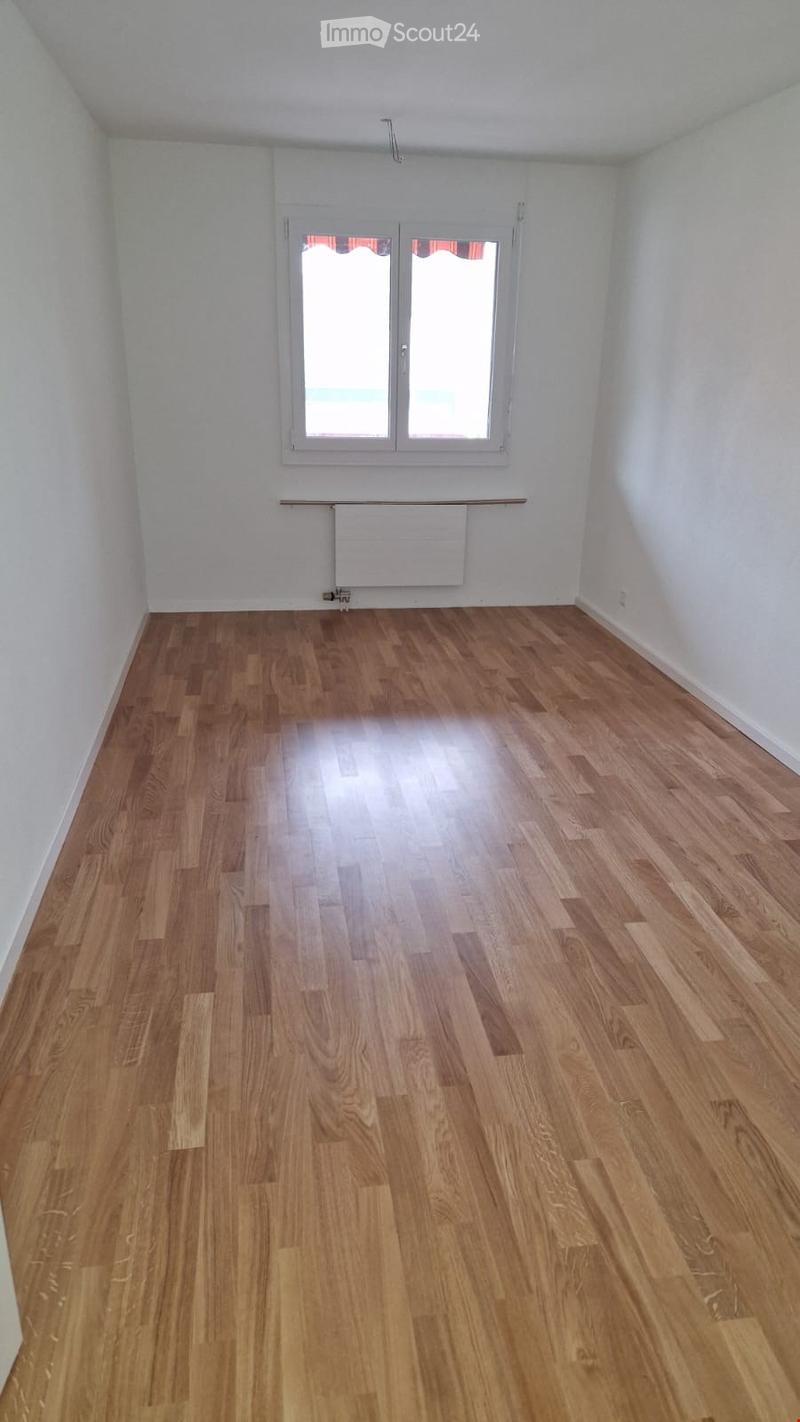 Empty room with wooden flooring, white walls, and a window with white frame. No furniture or equipment present.