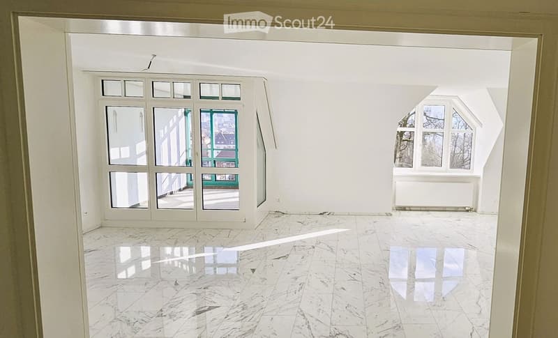 Empty room with white walls, polished marble floor, large windows, and a radiator. No furniture or equipment present.