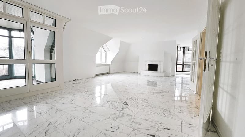 Bright, empty room with white walls, marble flooring, large windows, and a fireplace.