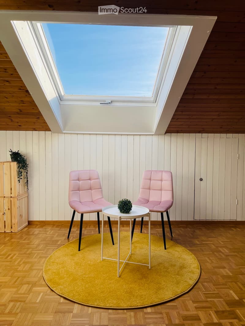 small attic room, sky window, yellow rug, round table, 2 pink chairs