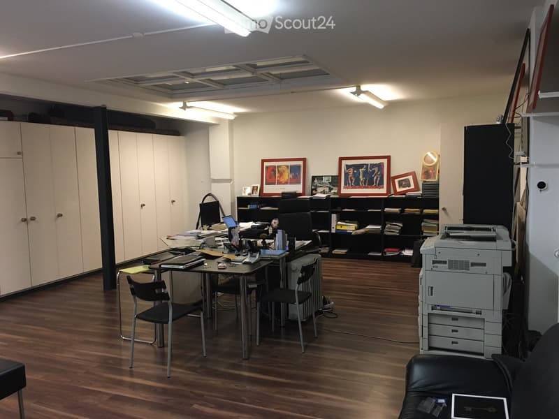 office with wooden floor, multiple desks, cabinets, shelves, office equipment