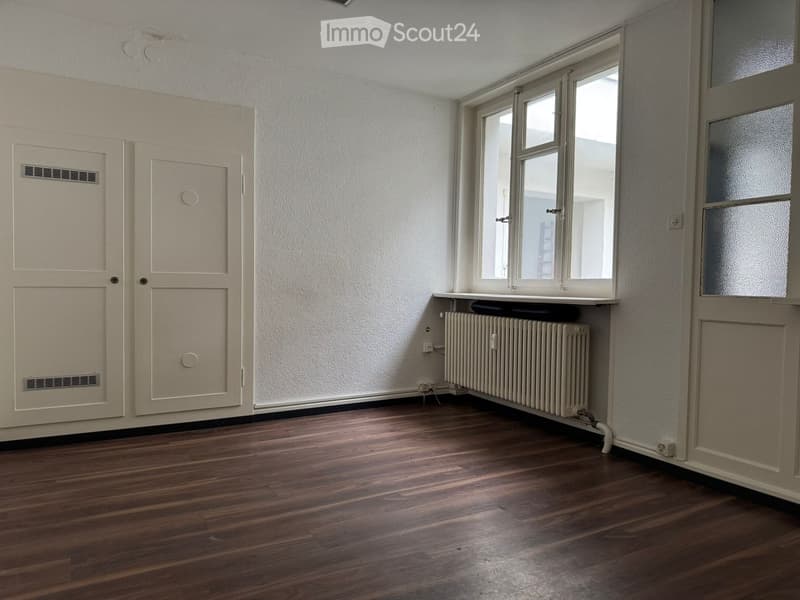 wooden floor, white radiator, window, double door, ventilation grilles