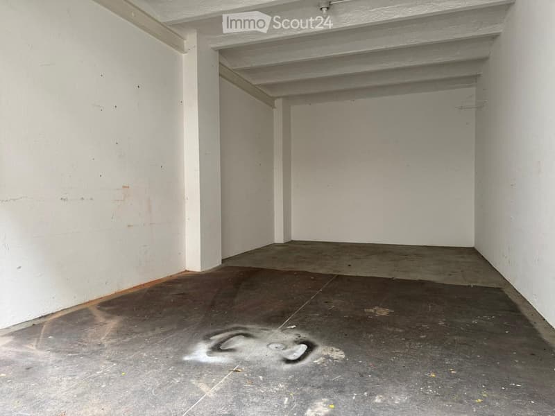 empty room, concrete floor, white walls, some paint stains on walls, unlit