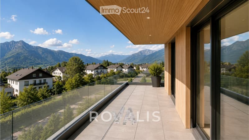Modern balcony with wooden ceiling, glass railing, and scenic mountain view.