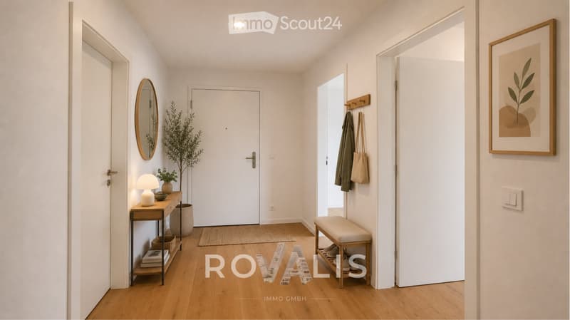 Modern hallway with light wooden flooring, white walls, a small table with a lamp, a mirror, a coat rack, and a bench. There are also potted plants and a framed picture on the wall.