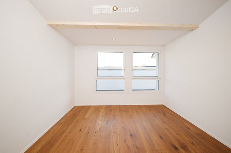 Completely empty room with bare white walls and wooden floor. No furniture or equipment.