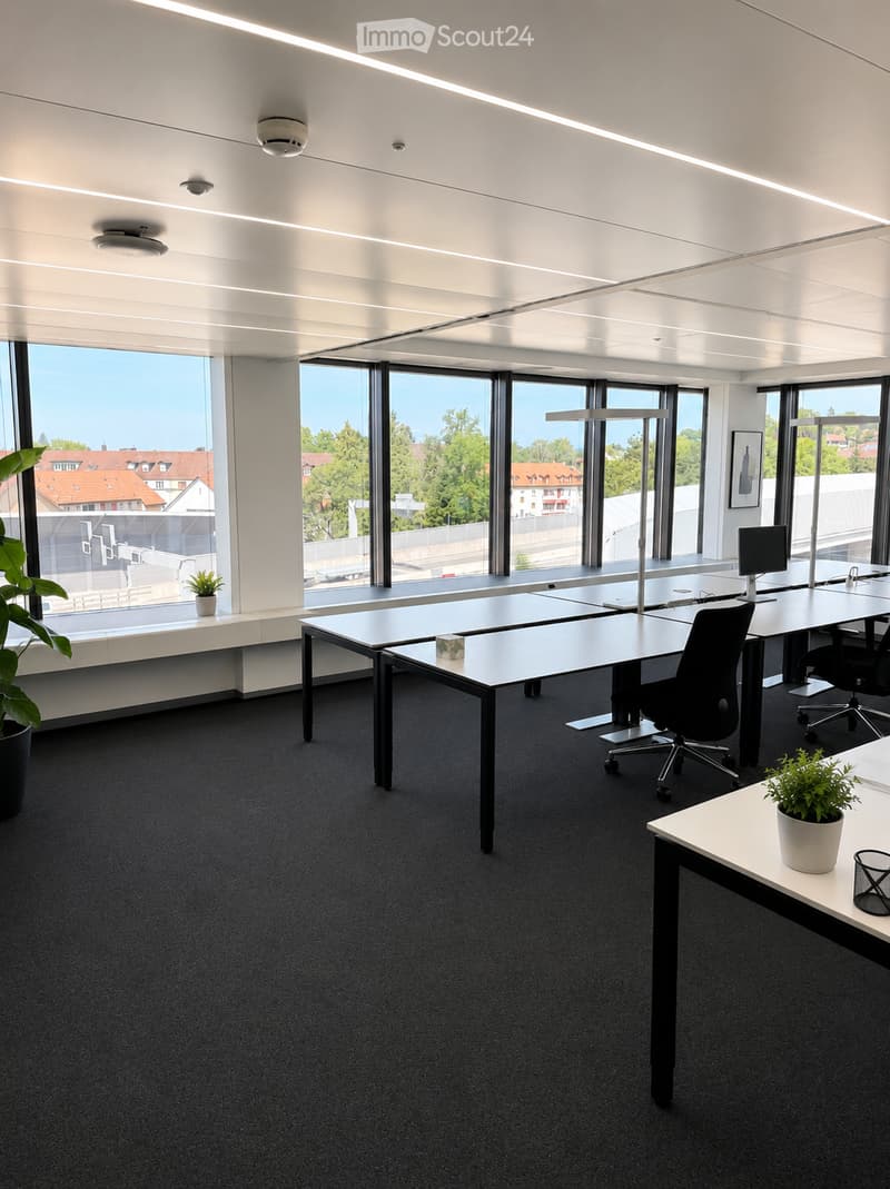 Modern office space with large windows, desks, chairs, and plants.