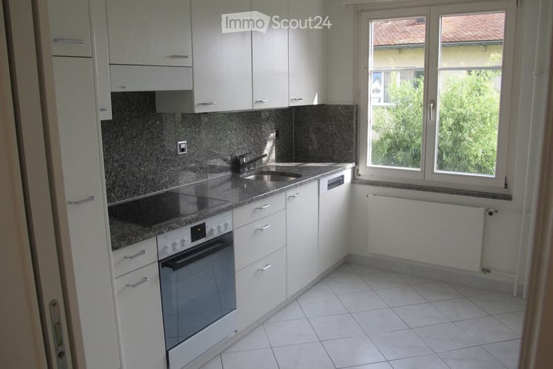 modern kitchen with white cabinets, granite countertops, stainless steel sink, electric stove, oven, dishwasher, power outlet, window