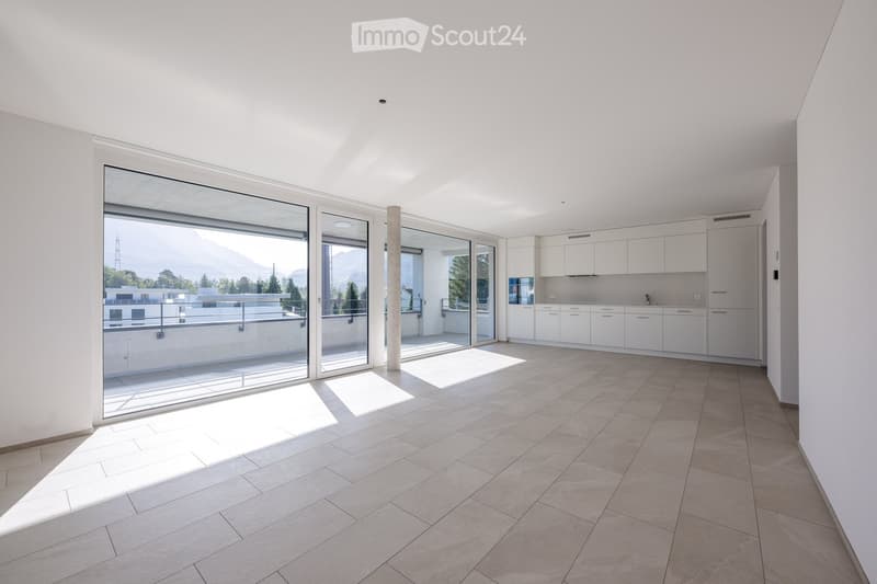 open layout with floor to ceiling windows, sliding glass doors, light tiled floor, modern white kitchen