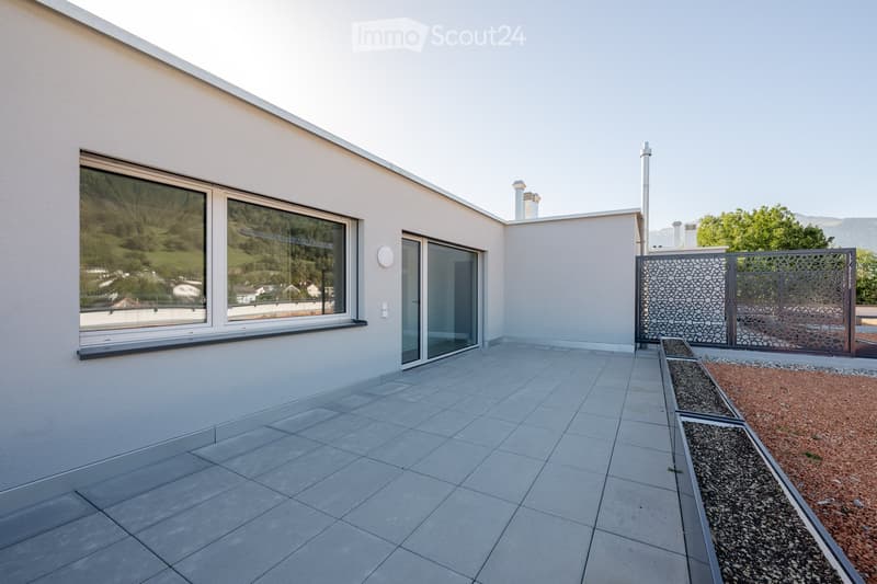 tiled floor, glass door, large windows, gray exterior wall, fenced perimeter