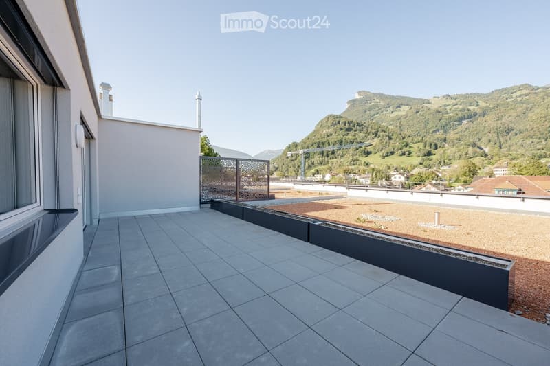 large balcony, tiled floor, metal railing, elevated view of mountain and town