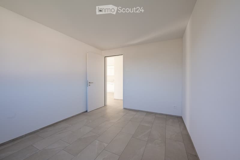 Empty room, white walls, tiled floor, doorway, open door leading to another room