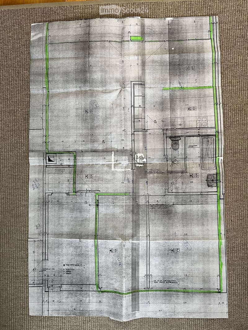 Floor plan of a residential building showing multiple rooms, including living areas, bedrooms, bathrooms, and a staircase. Dimensions and room labels are indicated.